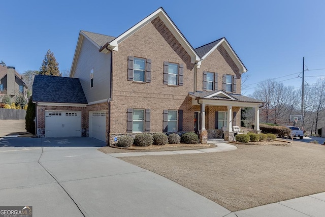 view of front facade featuring a garage, concrete driveway, and brick siding