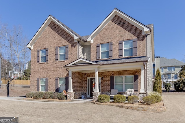 view of front of property with brick siding and a porch