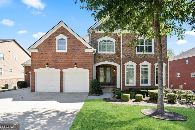 front facade featuring french doors, a garage, and a front lawn