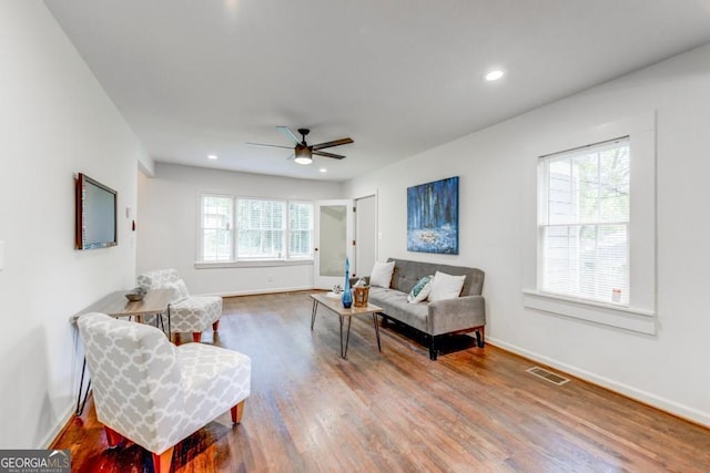 living room with hardwood / wood-style flooring and ceiling fan