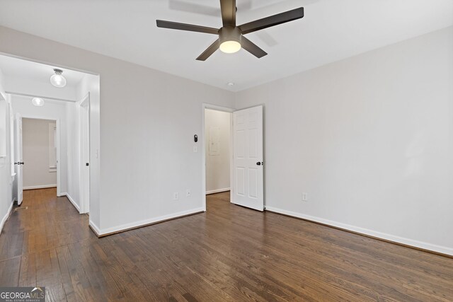 unfurnished bedroom with ceiling fan and dark hardwood / wood-style flooring