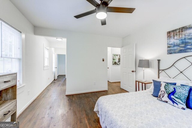 bedroom with dark wood-type flooring and ceiling fan