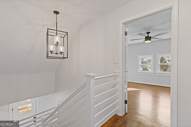 hall featuring hardwood / wood-style floors and a chandelier