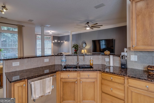 kitchen with dishwasher, sink, dark stone counters, kitchen peninsula, and crown molding