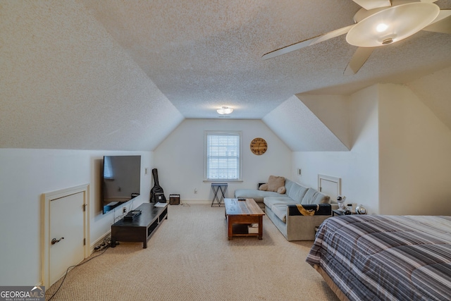 bedroom with light colored carpet, lofted ceiling, and a textured ceiling