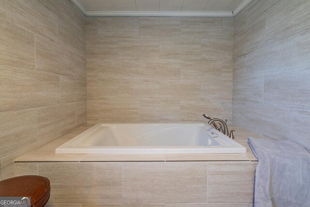 40 County Road 498, Centre, AL 35960 - full bathroom with ornamental molding, a garden tub, tile walls, and toilet