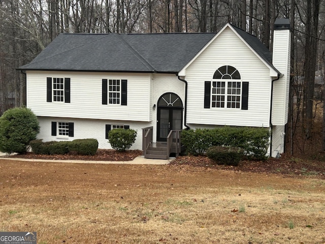 raised ranch with a front lawn