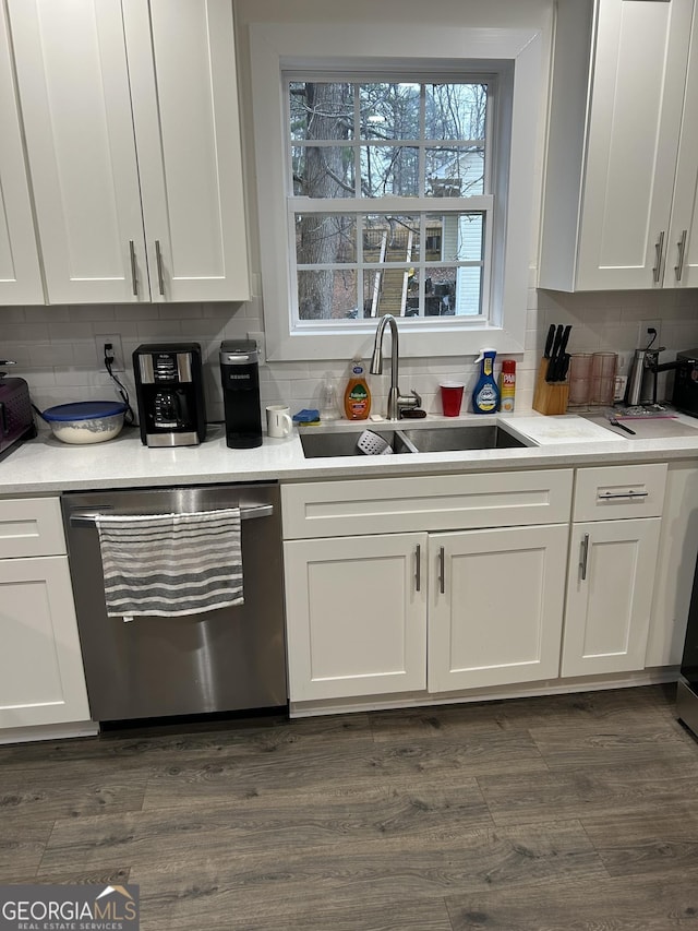 kitchen featuring white cabinetry, dishwasher, sink, and dark hardwood / wood-style floors