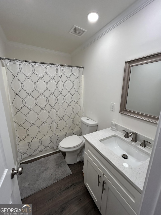 bathroom featuring hardwood / wood-style flooring, ornamental molding, toilet, and vanity