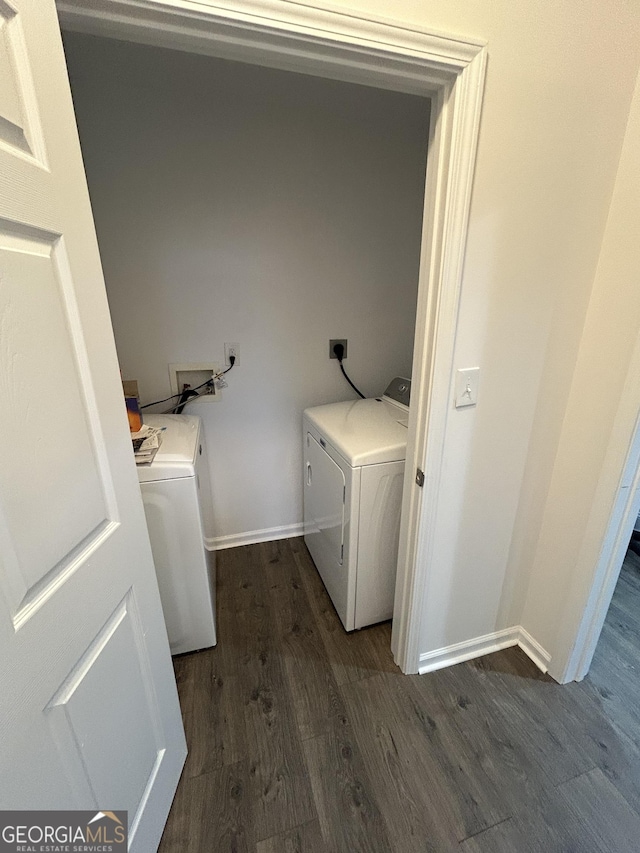 clothes washing area featuring washer and dryer and dark wood-type flooring