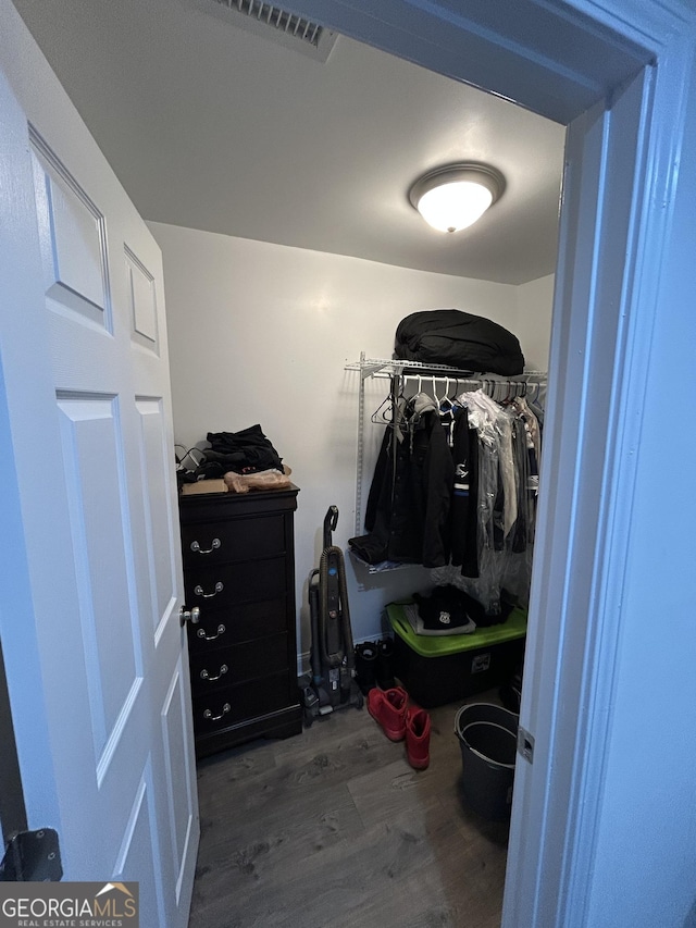 walk in closet with hardwood / wood-style floors