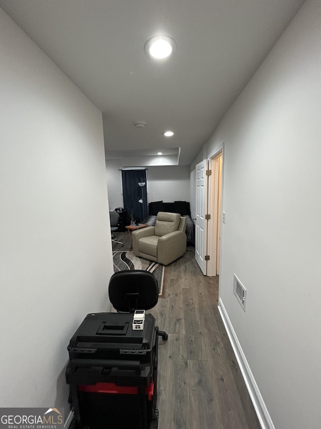 hallway with hardwood / wood-style flooring