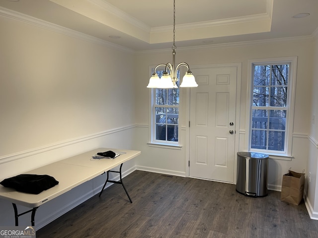 entrance foyer featuring ornamental molding, dark hardwood / wood-style floors, a chandelier, and a tray ceiling