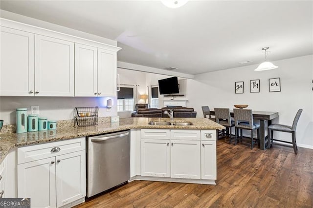 kitchen featuring pendant lighting, sink, dark wood-type flooring, dishwasher, and white cabinetry