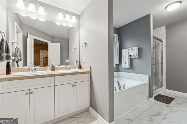 bathroom with vanity and shower with separate bathtub