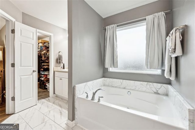 bathroom featuring vanity and a tub