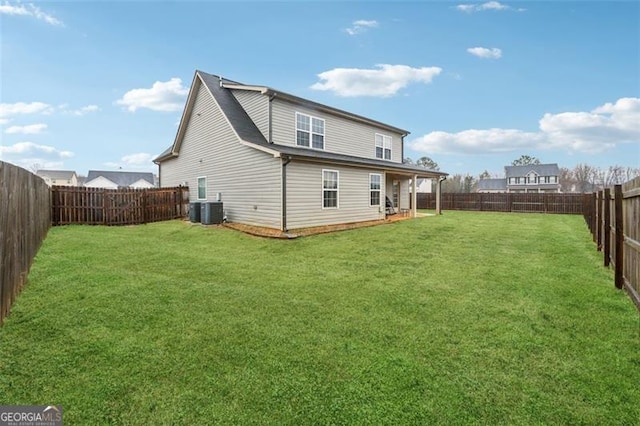 back of house with a yard and central AC