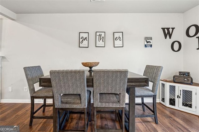 dining room with dark hardwood / wood-style flooring