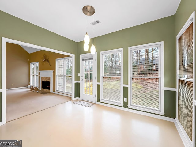 interior space featuring a premium fireplace, carpet, and a wealth of natural light