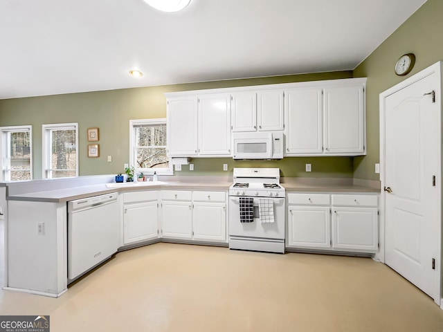 kitchen with sink, white appliances, and white cabinets