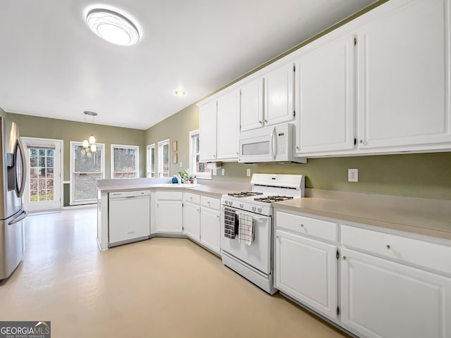 kitchen featuring white cabinetry, white appliances, pendant lighting, and kitchen peninsula