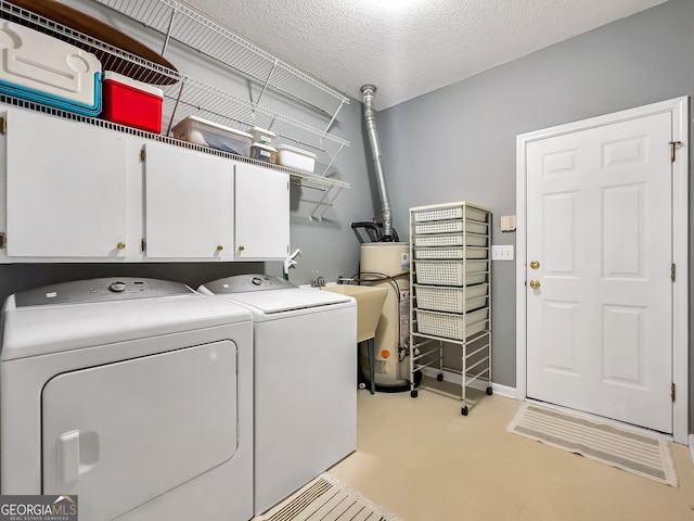 laundry room with sink, cabinets, gas water heater, a textured ceiling, and washing machine and clothes dryer