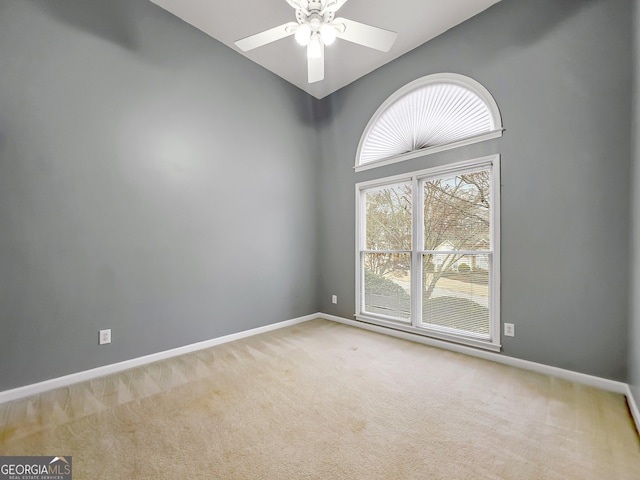 carpeted spare room featuring ceiling fan