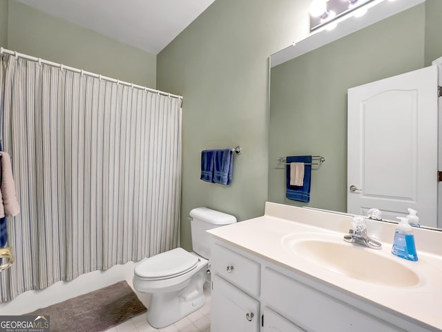 bathroom featuring vanity, tile patterned flooring, and toilet