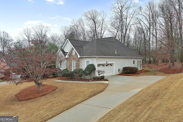 view of front property featuring a garage and a front yard