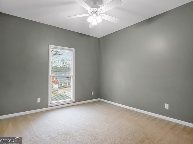 carpeted empty room featuring ceiling fan