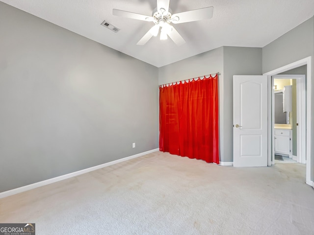 carpeted spare room with ceiling fan and a textured ceiling