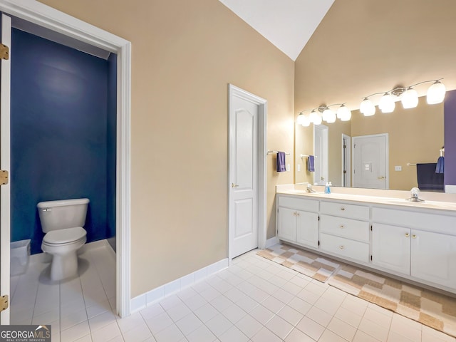 bathroom with lofted ceiling, toilet, tile patterned flooring, and vanity