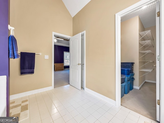 interior space with tile patterned flooring and lofted ceiling