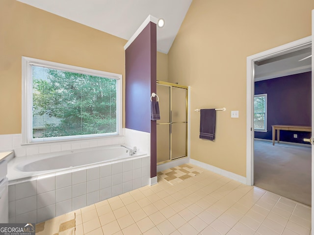 bathroom featuring lofted ceiling, tile patterned flooring, and separate shower and tub