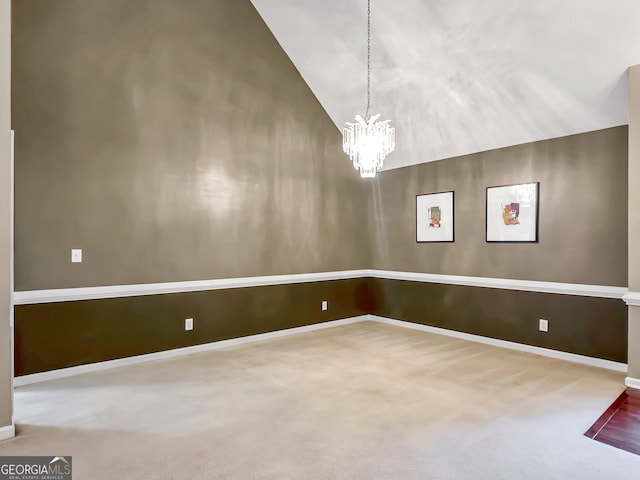 interior space with lofted ceiling, carpet flooring, and a notable chandelier