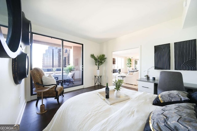 bedroom with dark hardwood / wood-style floors, multiple windows, and access to outside