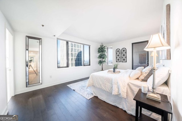 bedroom with dark hardwood / wood-style flooring