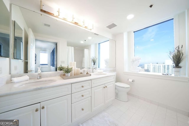 bathroom featuring vanity and toilet