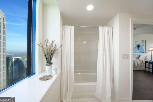 bathroom with shower / bath combo with shower curtain