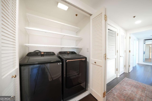 washroom featuring dark hardwood / wood-style flooring and washer and dryer