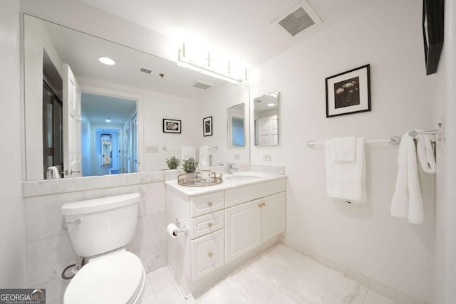 bathroom with tile patterned floors, vanity, and toilet