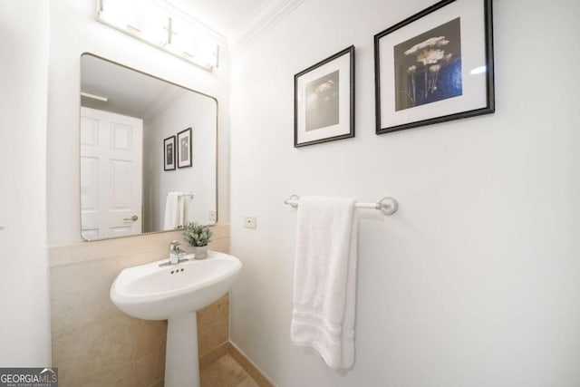 bathroom with ornamental molding and sink