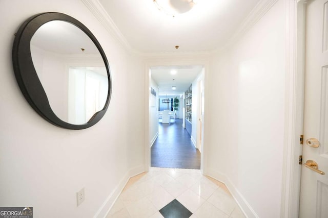 hall with crown molding and light tile patterned floors