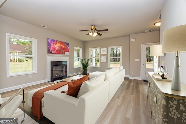 living room featuring hardwood / wood-style flooring and ceiling fan