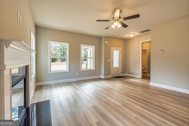 unfurnished living room with light hardwood / wood-style floors and ceiling fan