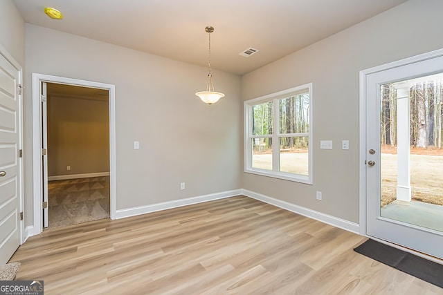 unfurnished dining area featuring light hardwood / wood-style floors