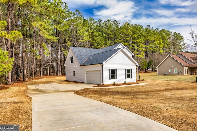 view of front of property featuring a garage and a front lawn