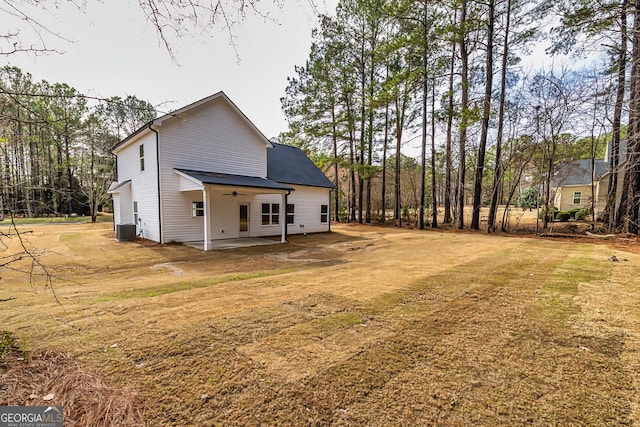 exterior space with a lawn, central AC unit, ceiling fan, and a patio area