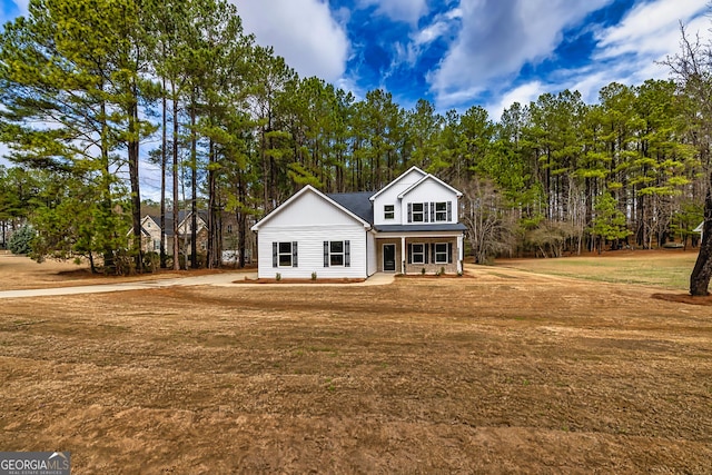 view of front of home with covered porch and a front lawn