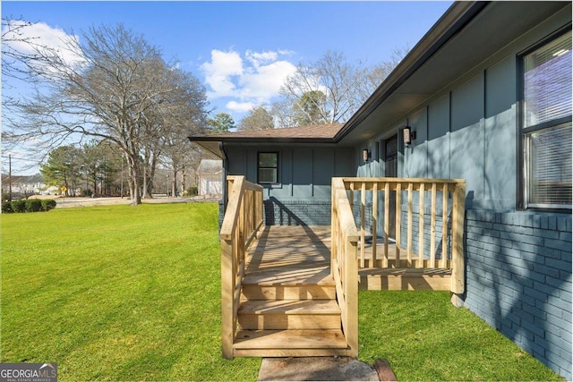 property entrance with a yard and a deck